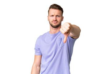 Young handsome caucasian man over isolated chroma key background showing thumb down with negative...
