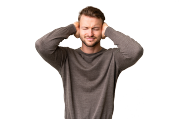 Young handsome caucasian man over isolated chroma key background frustrated and covering ears