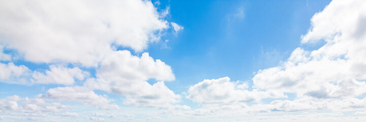 Fototapeta premium Beautiful view of blue sky with clouds. Beautiful shapes, partly cloudy. Colorful sunset. Natural sky background texture, beautiful color. Bright landscape in the blue sky.