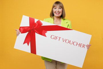 Elderly fun woman 50s years old wear green jacket white t-shirt hold big gift certificate coupon...