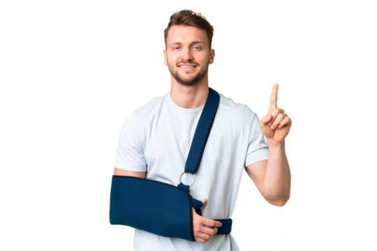Young caucasian man with broken arm and wearing a sling over isolated chroma key background showing and lifting a finger in sign of the best