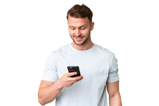 Young handsome caucasian man over isolated chroma key background sending a message or email with the mobile