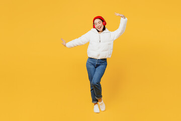 Full body cheerful young woman of Asain ethnicity wear white padded windbreaker jacket red hat...