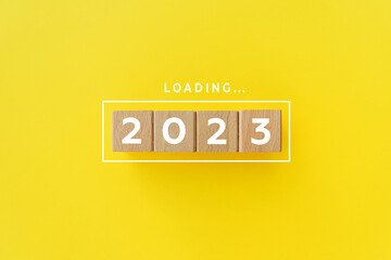 2023 New Year Loading. Loading bar with wooden blocks 2023 on blue background. Start new year 2023...