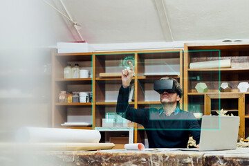Mature man wearing virtual reality simulator gesturing on transparent screen