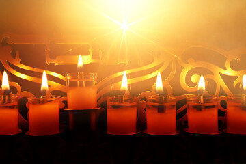 Image of jewish holiday Hanukkah menorah (traditional candelabra) with text that mean, HANUKKAH