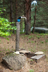 Naklejka premium Modern faucet in the backyard of the wooden houses to connect the hose and watering the plants