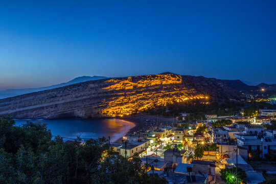 Greece, Crete, Matala, View of illuminated coastal village at night