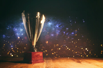 image of gold trophy with sparkly overlay over dark background