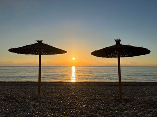 Parasol with sunrise on the beach in Albir