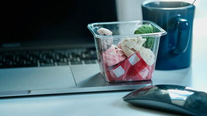 Multi-colored cookies laying on the desk.