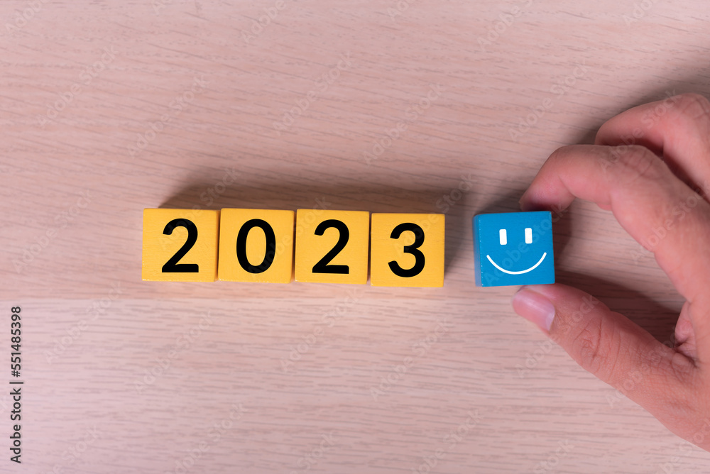 Poster hand pickup smile cube and abstract wood cube building block with text 2023 on it