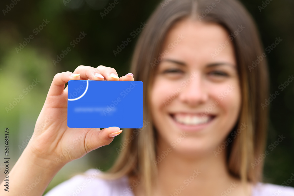 Wall mural Woman showing blank credit card