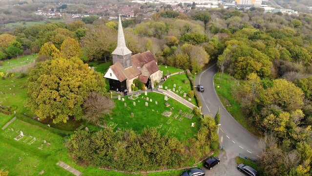Reverse aerial view of a church in Basildon on a cloudy day