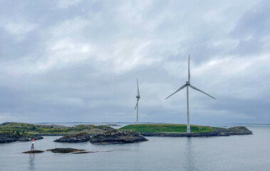 Wind turbines in the Norwegian fjords on a cloudy day