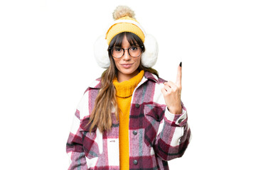 Young caucasian woman wearing winter muffs over isolated chroma key background pointing with the index finger a great idea