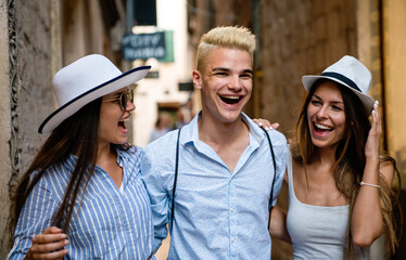 Group of happy friends enjoying travel and summer vacation together.