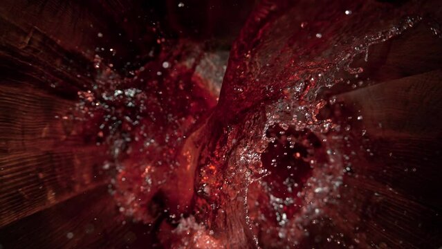 Super Slow Motion Shot of Pouring Red Wine into Old Oak Wooden Barrel at 1000fps.