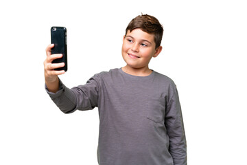 Little caucasian kid over isolated chroma key background making a selfie