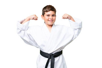 Little caucasian kid over isolated chroma key background doing karate and making strong gesture