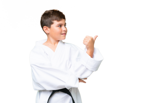 Little caucasian kid over isolated chroma key background pointing to the side to present a product