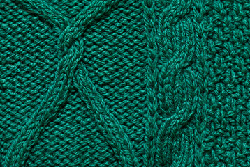 Macro green handmade woolen sweater fabric texture. Close up