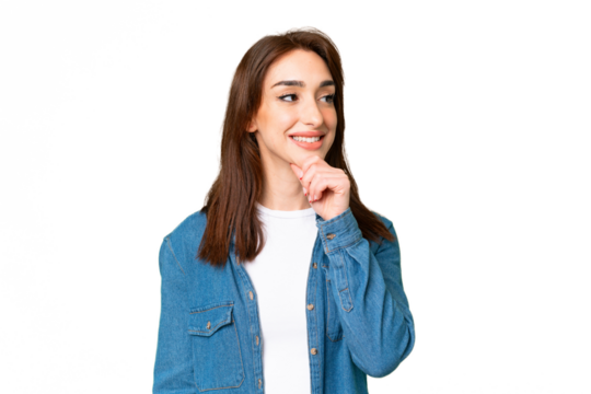 Young caucasian woman over isolated chroma key background looking up while smiling