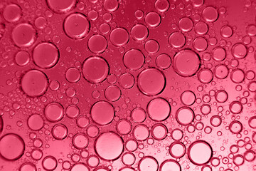 abstract light viva magenta background with oil circles . bubbles of water close up