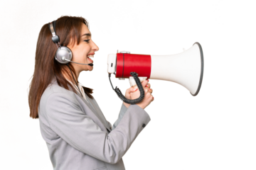 Telemarketer caucasian woman working with a headset over isolated chroma key background shouting through a megaphone