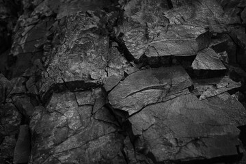 Black White. Rock texture. Cracked mountain surface. Close-up. Stone background for design. Grunge.
