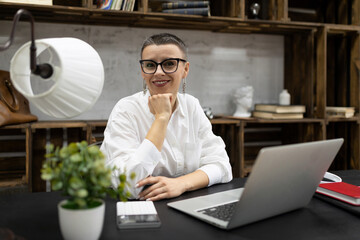 woman psychologist in glasses at her workplace in the office