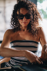 Portrait of a curly woman in sunglasses