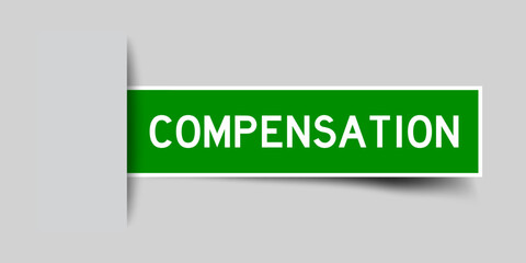 Inserted green color label sticker with word compensation on gray background
