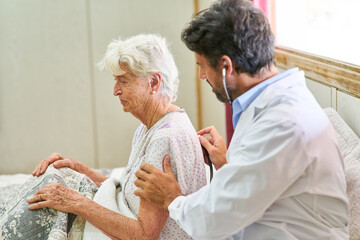 Doctor listening to a senior with a stethoscope