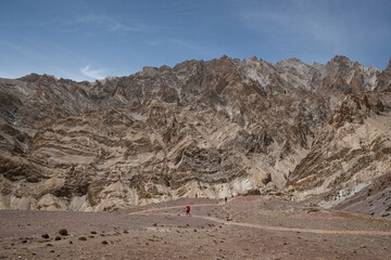A lone woman walking with a backpack in the Himalayas