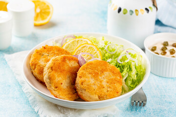 Fish cakes or burger, or cutlets. Made from ground perch and tuna with herbs, breaded and fried,...