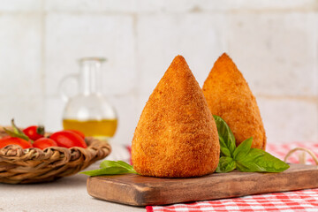 Italian rice balls stuffed, coated with breadcrumbs and deep fried.  Conical-shaped arancini.  Filled with ragu, minced meat, caciocavallo cheese and green peas. Sicilian - obrazy, fototapety, plakaty
