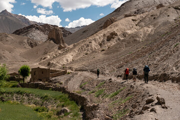 People walking with backpacks in the mountains. trekking in the Himalayas in India. Ladakh Mountains