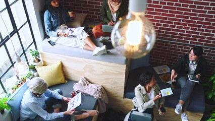 Top view of business people, marketing team and women planning creative strategy, ideas or innovation in creative startup. Female led advertising agency, designers and meeting for group collaboration