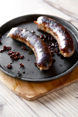 grilled sausages on a wooden background