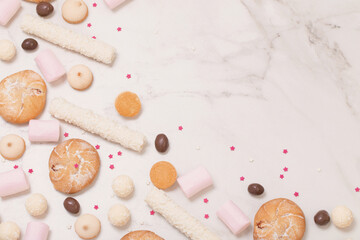 Fototapeta na wymiar candies and cookies on white marble background