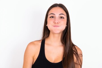 Young caucasian woman wearing sportswear over white background  puffing cheeks with funny face....