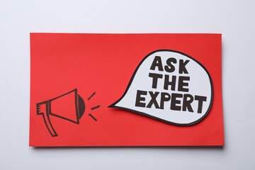 Red card with drawn loudspeaker and phrase Ask The Expert on light background, top view