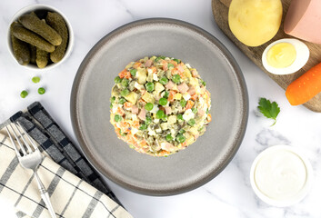 Russian olivier salad and ingredients for cooking on a gray background, top view. Russian Olivier salad. Russian New Year salad 