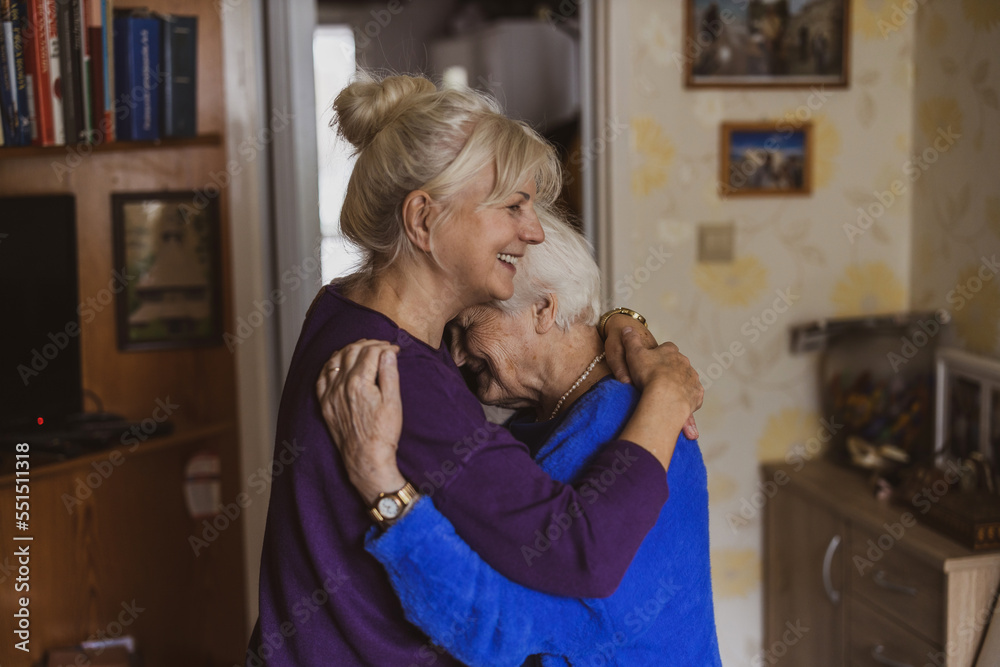 Poster Woman hugging her elderly mother
