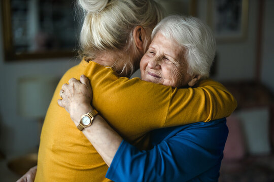 Woman hugging her elderly mother
