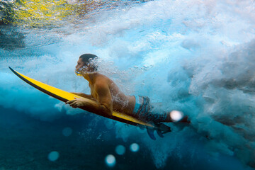 Shirtless male surfer diving in sea at Maldives - 551512185
