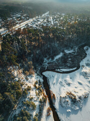 Aerial view on beautiful Baltic sea shore by the pine forest in winter season, winter landscape