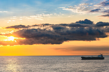 Naklejka na ściany i meble Oil Tanker Ship at Mediterranean Sea at sunrise, Barcelona, Spain, Europe