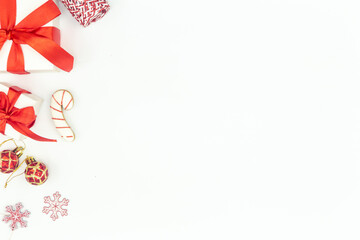 White Christmas background with gifts and holiday decor details, flat lay.